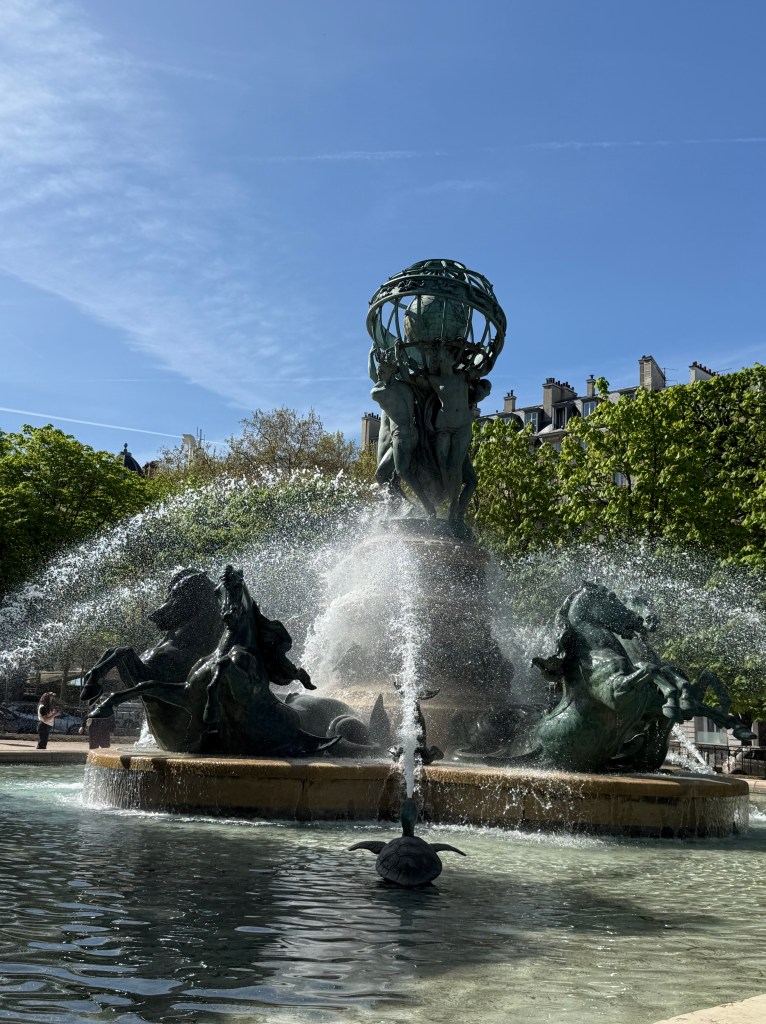 Another view of the fountain featuring the horses in the basin around the fountain.