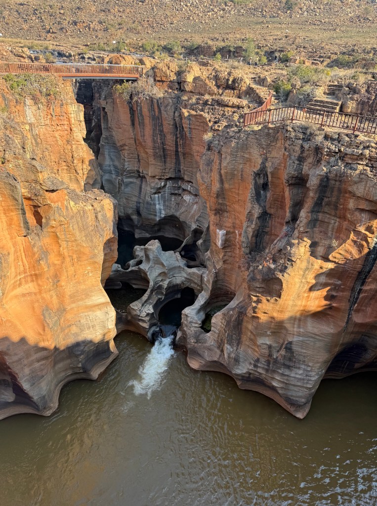 This is a more distant shot of the potholes and the golden cliffs.