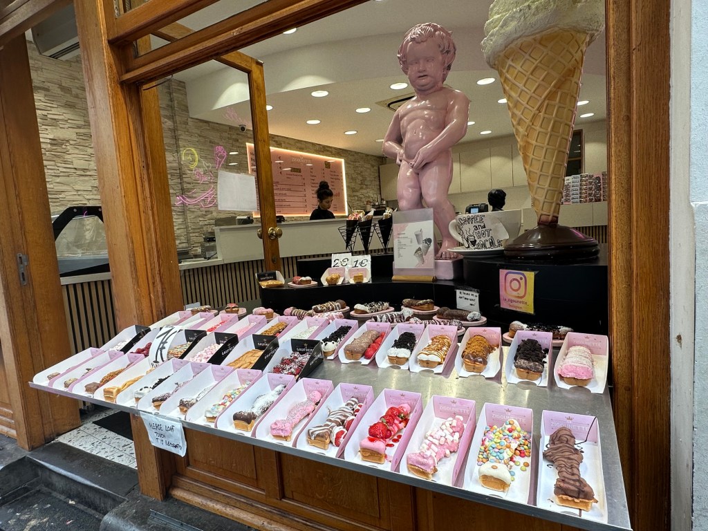 Chocolate shop with a lot of chocolate on display and a chocolate rendition of Mannekin Pis